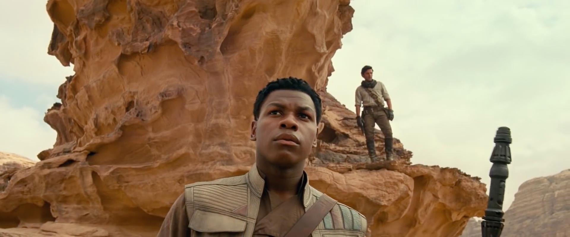 Poe and Finn hangin out on some rocks in the desert